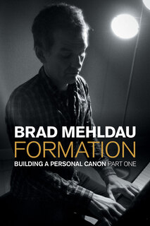 photo of Brad at the piano, looking down as he strikes keys