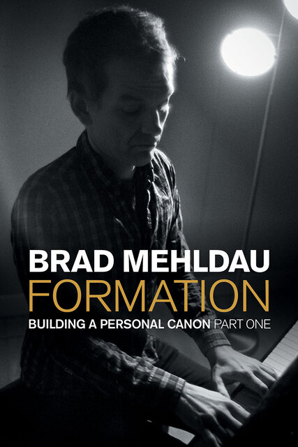 photo of Brad at the piano, looking down as he strikes keys