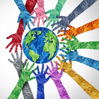 multicolored outstretched hands reaching towards a globe suggesting humanity 