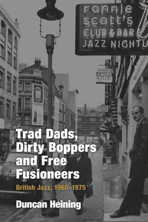 1960s photo showing entrance to Ronnie Scott's club in London's Soho district with man smoking in doorway