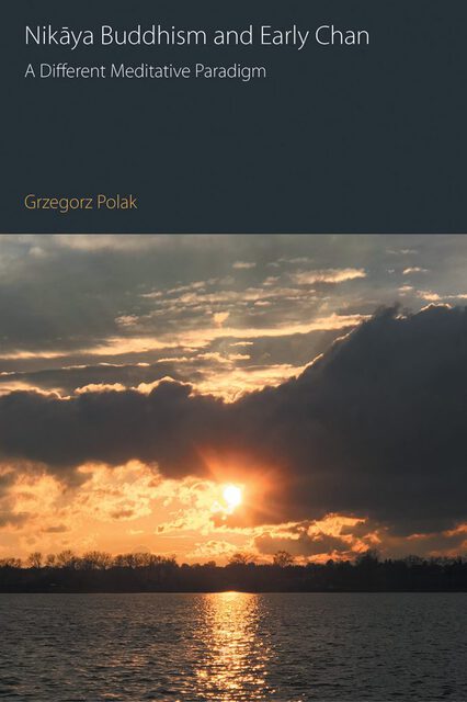 cover features a sunset over a lake