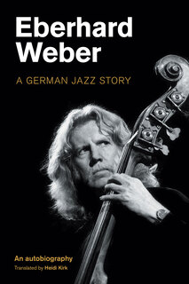 Weber playing bass and glancing sideways, as at fellow player