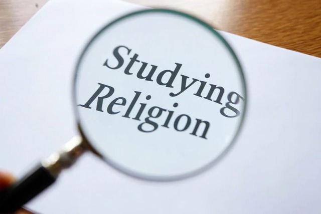 magnifying glass and words studying religion