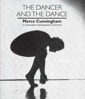 Photo of Cunningham on bent knees, looking down, on tiptoe with hands clasped together close to floor
