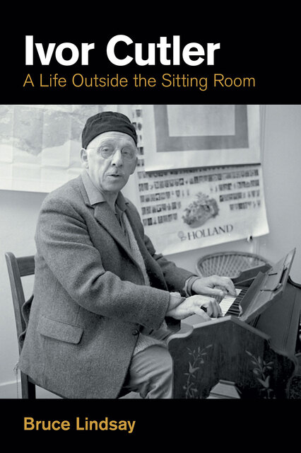 photo of Ivor at an upright piano wearing hat