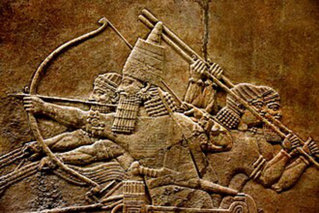 7th-century BC relief depicting Ashurbanipal, r. 669–631 BC, and three royal attendants in a chariot.