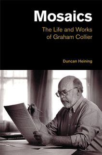 photo of Collier working on a score sitting at a desk, pencil in hand