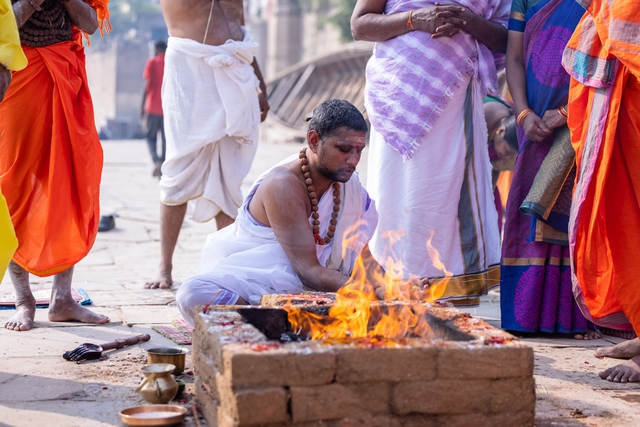 Hindu priest lighting a fire