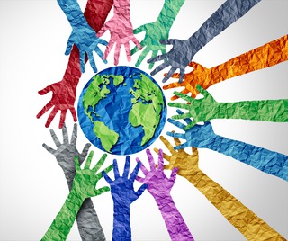 multicolored outstretched hands reaching towards a globe suggesting humanity 